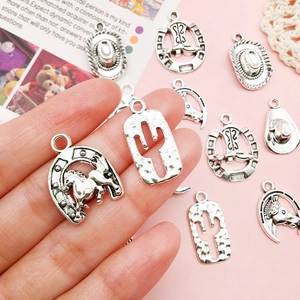 Assorted vintage silver Western cowboy charms including horseshoe and cactus for DIY jewelry