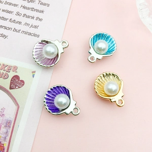 Detail of shell charms with pearls and enamel for DIY jewelry making