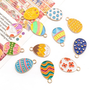 Detailed view of colorful enamel Easter egg charms with various patterns for DIY jewelry