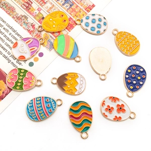 Macro view of colorful Easter rabbit and floral egg enamel alloy charms for DIY jewelry