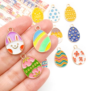 Detail shot of colorful Easter egg charms with cartoon rabbit and floral enamel patterns