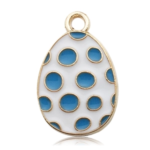 Macro detail of egg-shaped metal charm with blue polka dots and gold-plated edges