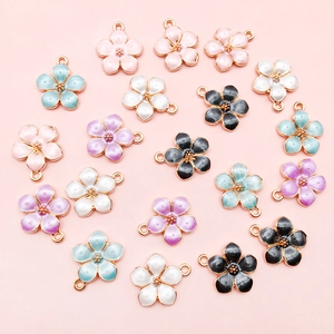 Macro shot of colorful enamel five-petal flower pendants with gold-plated alloy edges