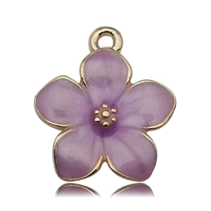 Macro view of purple enamel flower pendant with gold metal edges for DIY jewelry making