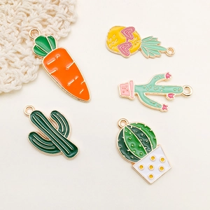 Macro detail of cartoon cactus and pineapple alloy enamel charms for DIY jewelry making