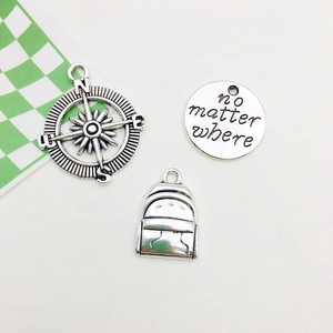 Retro silver graduation charm set with compass, backpack, and No Matter Where engraved plate