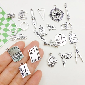 Silver alloy graduation charms set featuring graduation cap, books and school bus