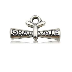 Detailed macro view of silver alloy diploma scroll charm with GRADUATE engraving and hanging loop