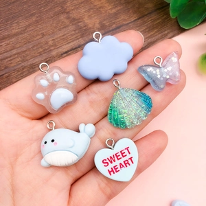 Blue resin charm set with cloud, butterfly and whale designs for DIY jewelry making