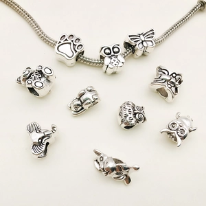 DIY silver snake chain bracelet set featuring owl and animal charms on a white background