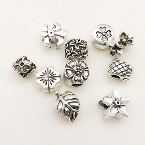 Vintage silver alloy charms set featuring floral, leaf, and clover shapes for DIY jewelry