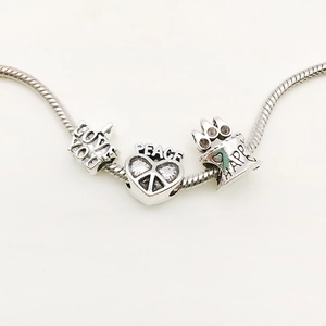 Silver charm bracelet with engraved Love You, Peace, and Happy pendants for women
