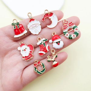 Detailed view of enamel Christmas charms including Santa, reindeer, and wreaths for DIY jewelry