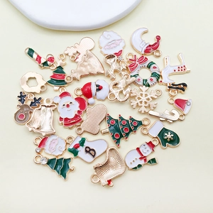Macro view of Christmas alloy enamel charms featuring Santa, tree and reindeer designs