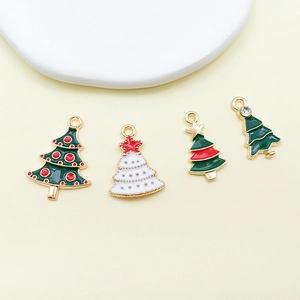 Macro shot of assorted Christmas enamel charms with gold alloy base and festive colors