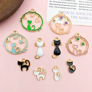 Close-up of cat-themed DIY alloy charms in pastel enamel for jewelry making