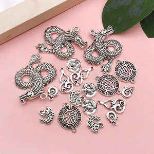 Detailed close-up of retro silver dragon and Fu character pendants in punk vintage style