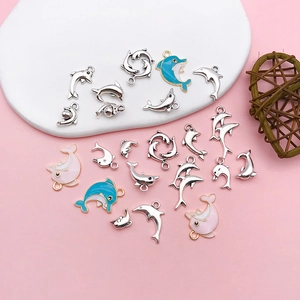 Macro detail of various colorful dolphin alloy charms for DIY jewelry making and crafts