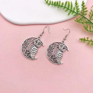 Antique silver owl and crescent moon drop earrings with intricate Celtic knot engraving