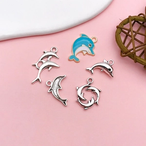 Detailed view of dolphin charms for DIY jewelry making in blue enamel and silver alloy