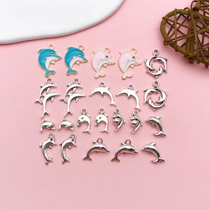 Detailed flat lay of colorful dolphin charms and silver alloy pendants for DIY jewelry making