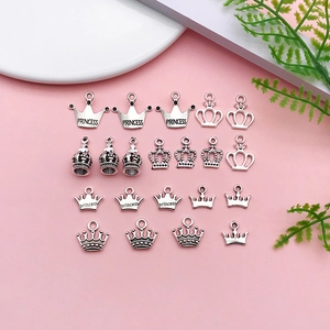 Macro detail of antique silver crown charms with Princess engraving for DIY jewelry