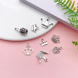 Macro shot of antique silver crown charms with Princess engraving for DIY jewelry making