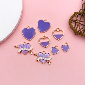 Detail of assorted purple heart-shaped alloy charms for DIY jewelry and necklaces