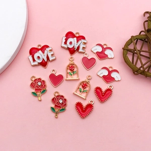 Detail of red heart and rose charms for jewelry making with shiny gold ring finish