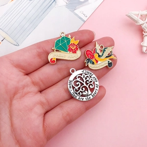 Drei Muttertag Emaille Anhänger mit Proud Mama und Awesome Mama Designs in der Hand gehalten