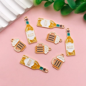Detailed view of creative beer bottle acrylic charms on a pastel pink background
