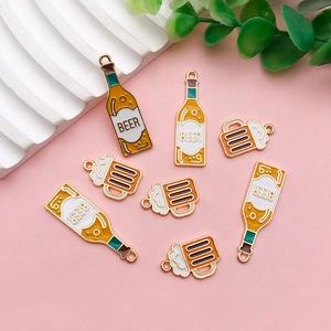 Detailed macro view of beer bottle and mug acrylic charms for DIY jewelry making