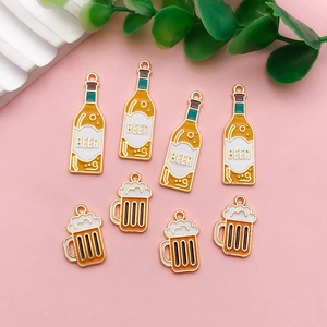 Detailed view of novelty beer bottle and mug acrylic charms for Oktoberfest earrings