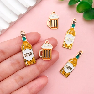 Macro detail of enamel beer bottle and cup pendants for creative DIY jewelry making