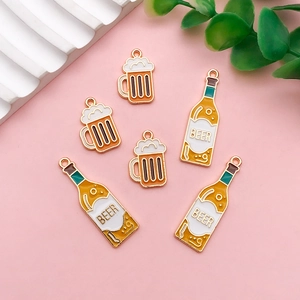 Macro detail of acrylic beer bottle and mug charms for creative DIY festive earrings