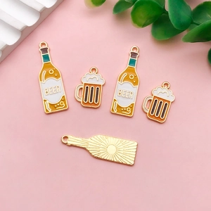 Detailed close-up of acrylic beer bottle and mug charms for Oktoberfest earrings