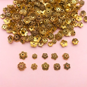 Vue détaillée de diverses calottes de fleurs en alliage d'or antique pour bijoux DIY