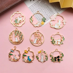 Detail view of ten assorted KC gold enamel cat pendants for DIY jewelry making