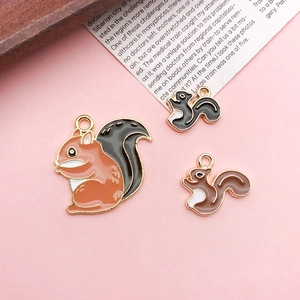 Detailed view of three squirrel enamel alloy charms for DIY jewelry making and crafts