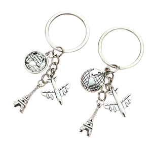 Travel keychain set with silver Eiffel Tower, globe and airplane charms for bags