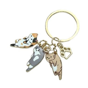 Cartoon cat keychain with gold ring featuring three colorful kittens and a paw charm