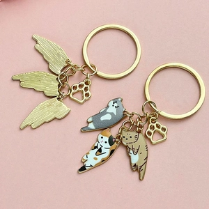 Golden cat claw keychain set with creative wings and colorful enamel cat pendants