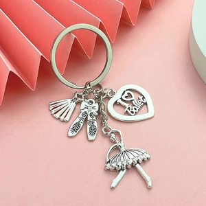 Detail of silver ballet keychain featuring tutu, pointe shoes, and I Love Ballet heart charm
