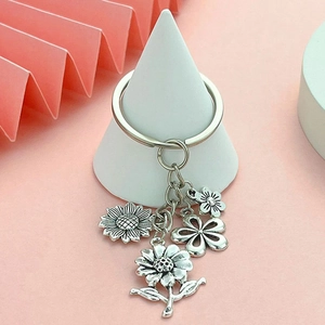 Vintage silver metal keychain with exquisite sunflower and daisy charms on a secure ring