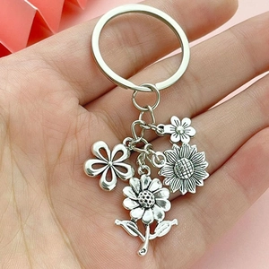 Silver sunflower and daisy multi-pendant keychain with four detailed flower charms