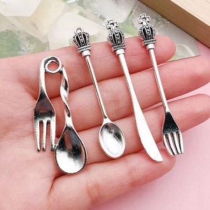Miniature vintage crown cutlery charms set held in hand for DIY jewelry making accessories