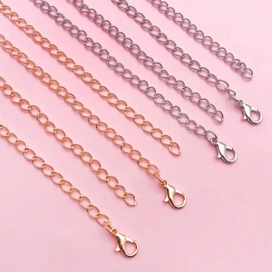 Detail of five 10-13cm extender chains in silver and rose gold with lobster clasps