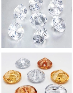 Detailed view of faceted round crystal diamonds in clear, gold, and amber orange hues