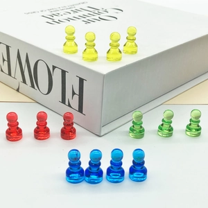 Colorful transparent acrylic pawn game pieces in red yellow blue and green colors