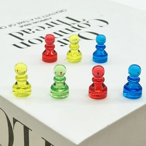 Translucent resin pawn board game pieces in vibrant red, yellow, blue, and green colors